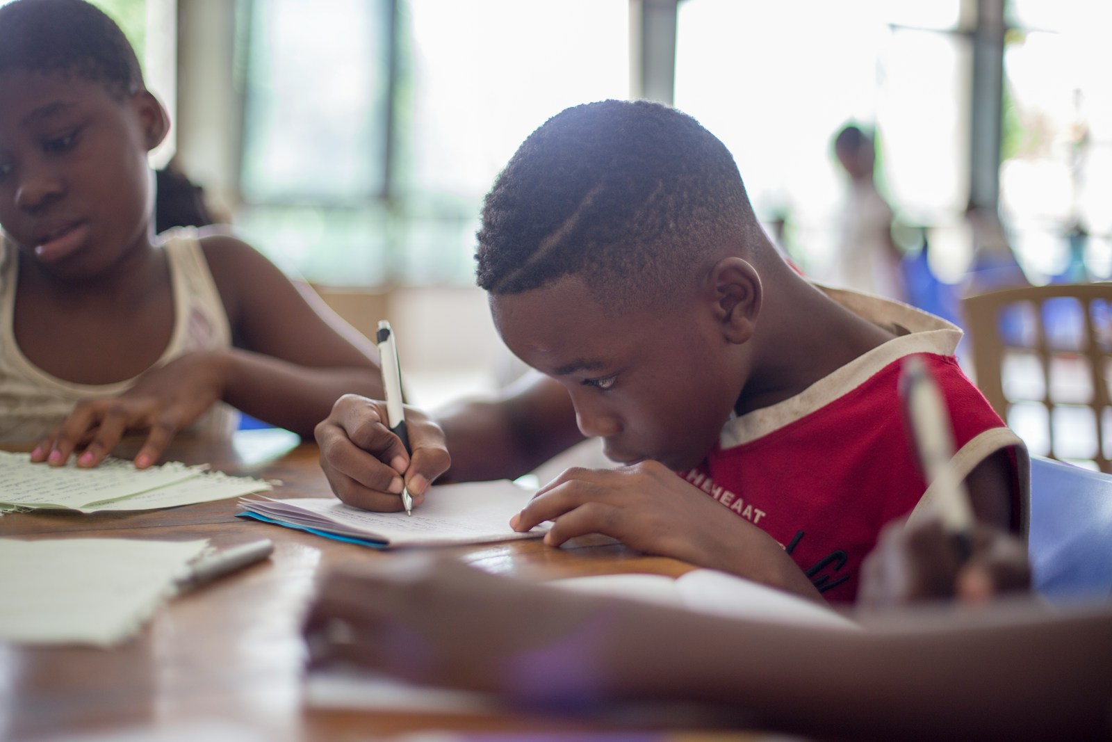 Two children studying side by side